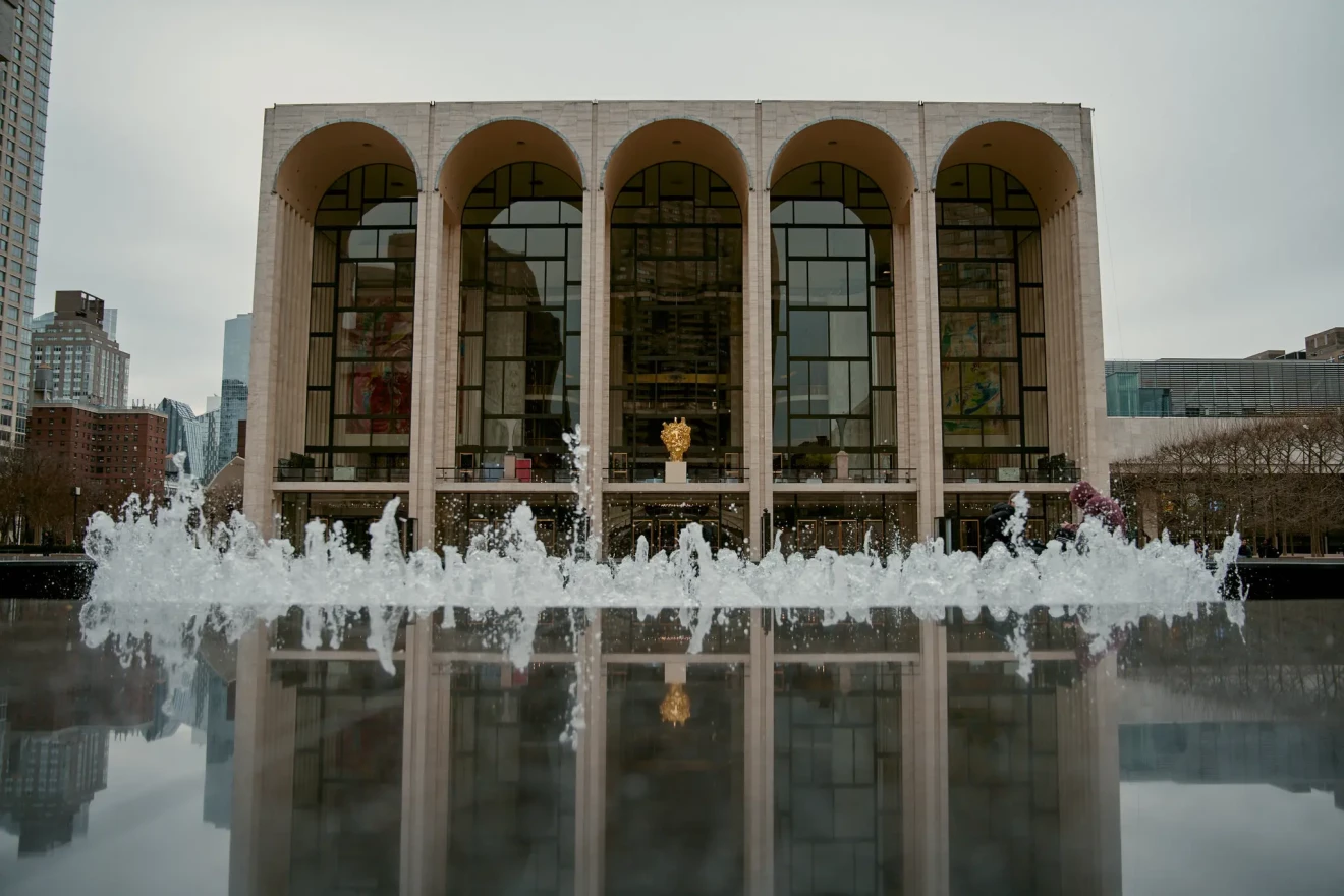 Metropolitan Opera house with reflection in pool and fountain